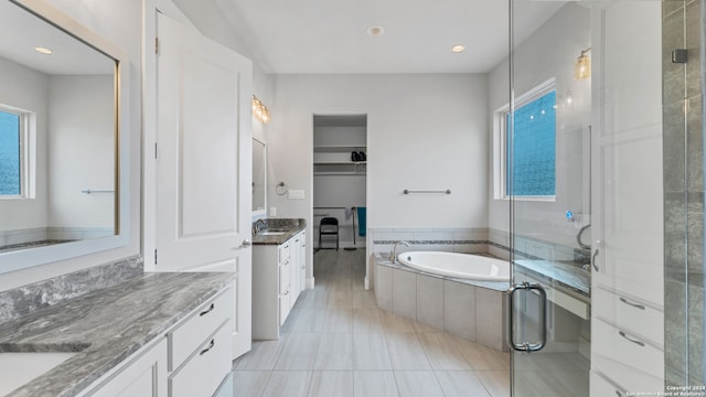 bathroom featuring tile patterned floors, separate shower and tub, and vanity