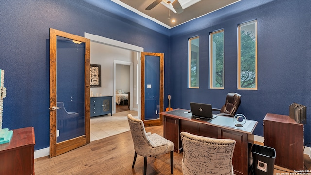 home office with ceiling fan and light hardwood / wood-style floors