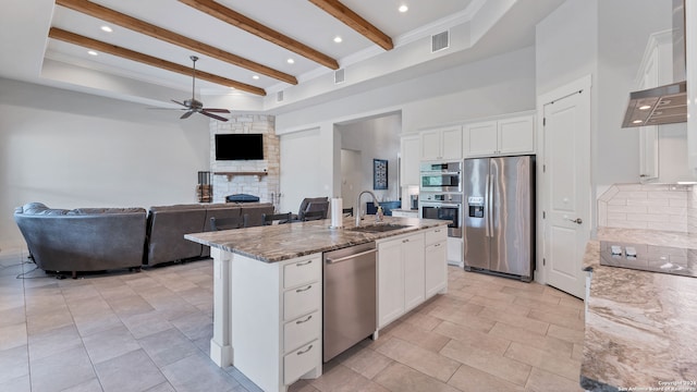 kitchen featuring white cabinets, stone counters, stainless steel appliances, sink, and ceiling fan