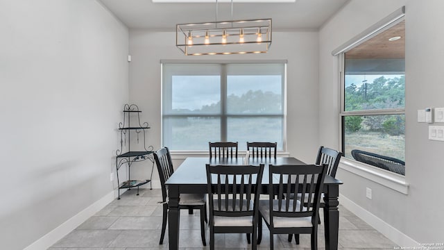 tiled dining space with a notable chandelier