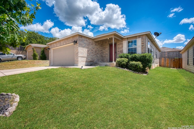 ranch-style house featuring a garage and a front lawn