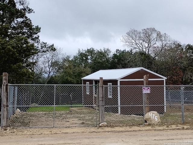 view of gate featuring an outdoor structure