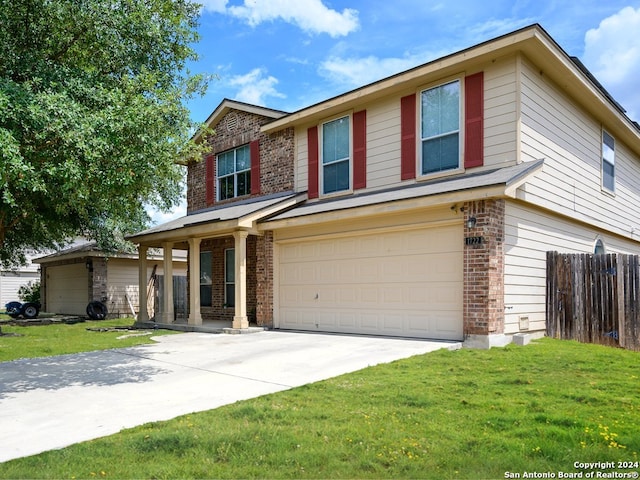 view of front of home featuring a front yard and a garage