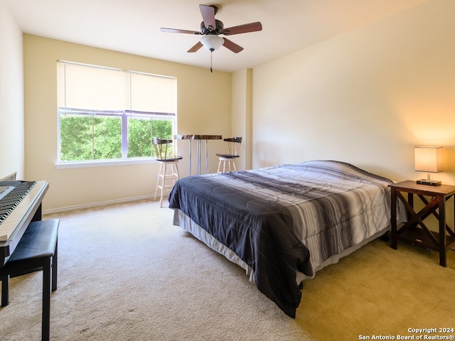 bedroom featuring light carpet and ceiling fan