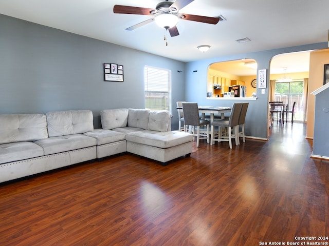 living room featuring dark hardwood / wood-style flooring and ceiling fan