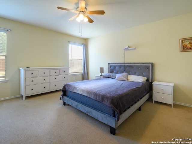 bedroom with light colored carpet and ceiling fan