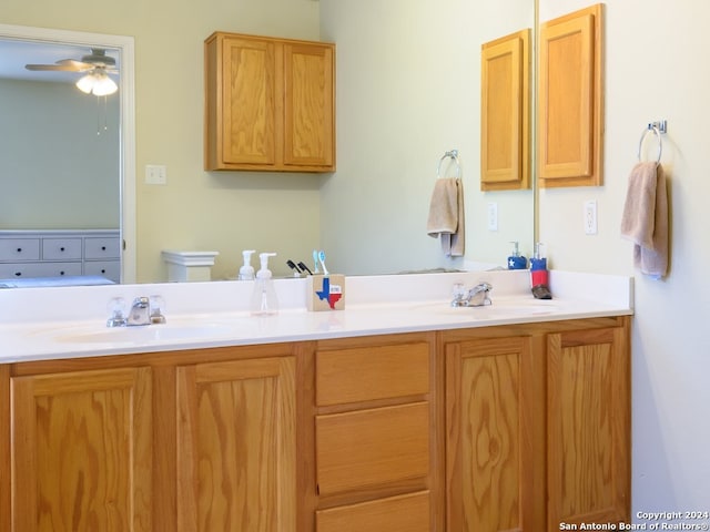 bathroom featuring ceiling fan and vanity