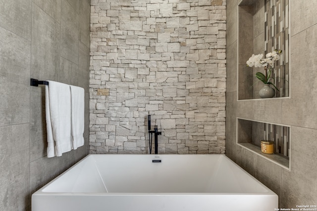 bathroom featuring a tub to relax in