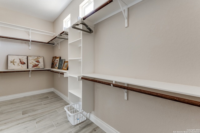 spacious closet with light hardwood / wood-style flooring