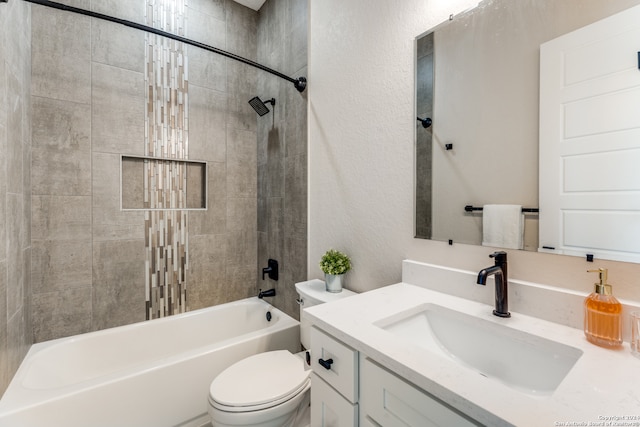 full bathroom with vanity, toilet, and tiled shower / bath combo