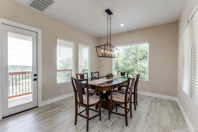 dining room featuring light hardwood / wood-style flooring and a chandelier