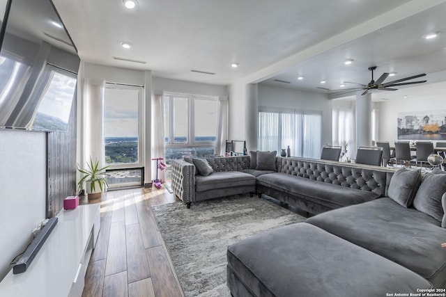 living area featuring wood finished floors, a ceiling fan, and recessed lighting