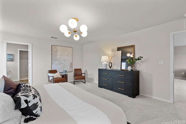 bedroom featuring light colored carpet, connected bathroom, and an inviting chandelier