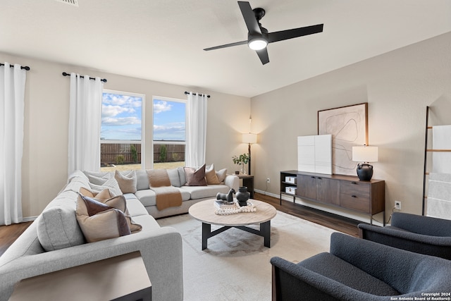 living room with hardwood / wood-style floors and ceiling fan