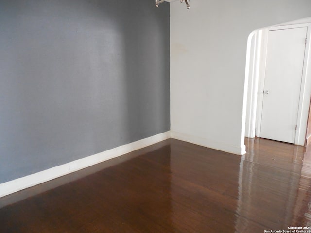 unfurnished room featuring dark hardwood / wood-style flooring