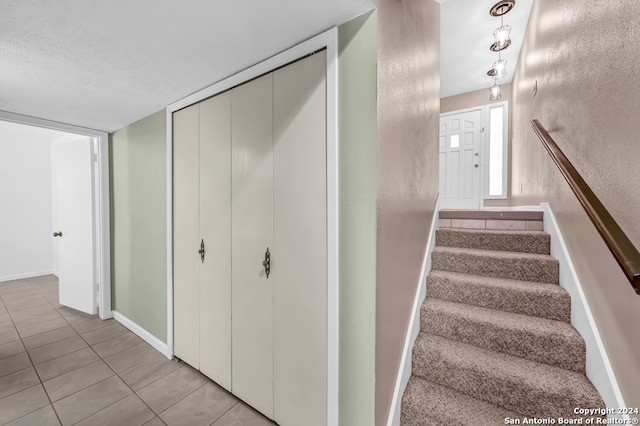 staircase with tile patterned floors