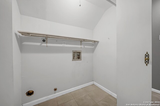 clothes washing area featuring light tile patterned floors and washer hookup