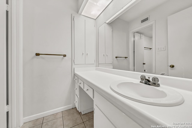 bathroom featuring tile patterned flooring and vanity