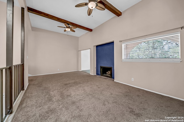 unfurnished living room featuring vaulted ceiling with beams, carpet floors, and ceiling fan