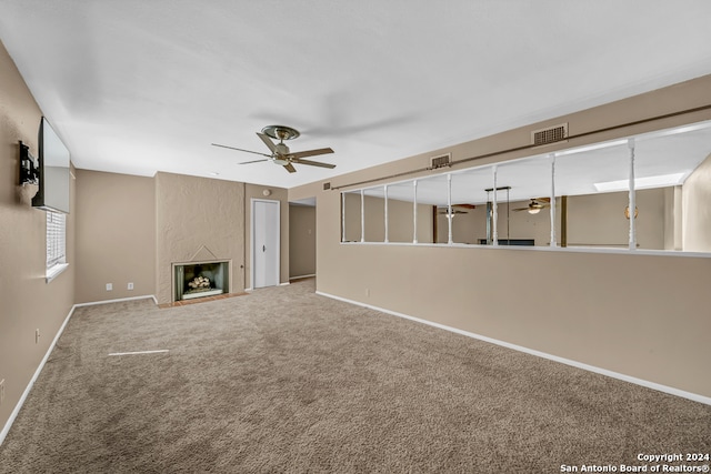 unfurnished living room with carpet, ceiling fan, and a premium fireplace