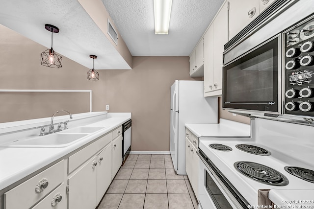 kitchen featuring white cabinets, sink, a textured ceiling, decorative light fixtures, and stainless steel appliances