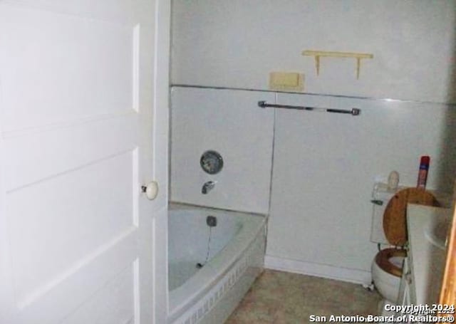 bathroom featuring toilet and  shower combination