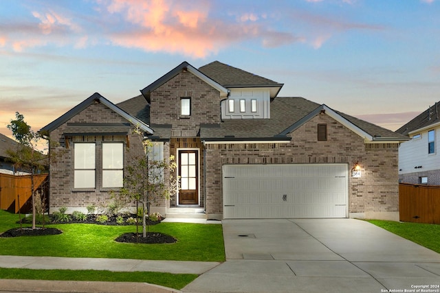 view of front facade with brick siding, a shingled roof, concrete driveway, an attached garage, and fence