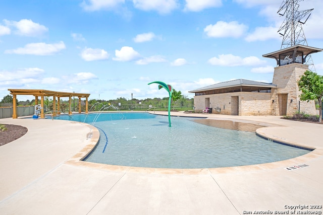 view of pool with pool water feature and a patio