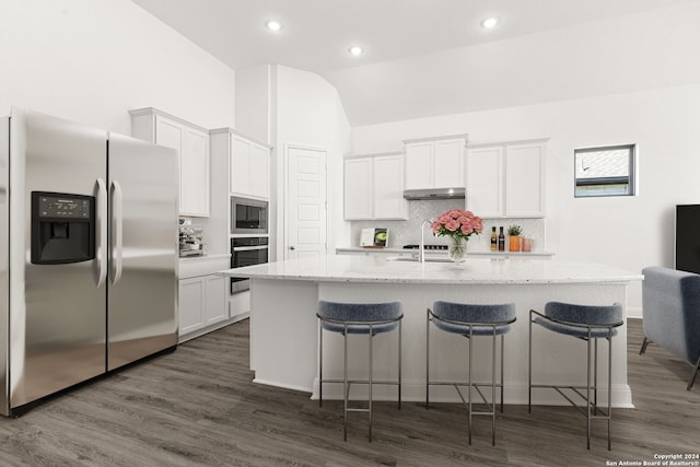 kitchen featuring a kitchen island with sink, white cabinets, and appliances with stainless steel finishes