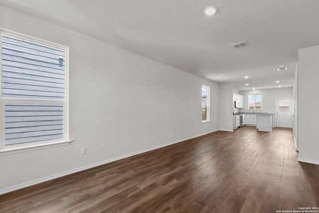 unfurnished living room featuring dark hardwood / wood-style flooring