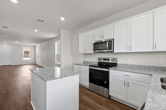 kitchen featuring appliances with stainless steel finishes, a center island, and white cabinetry