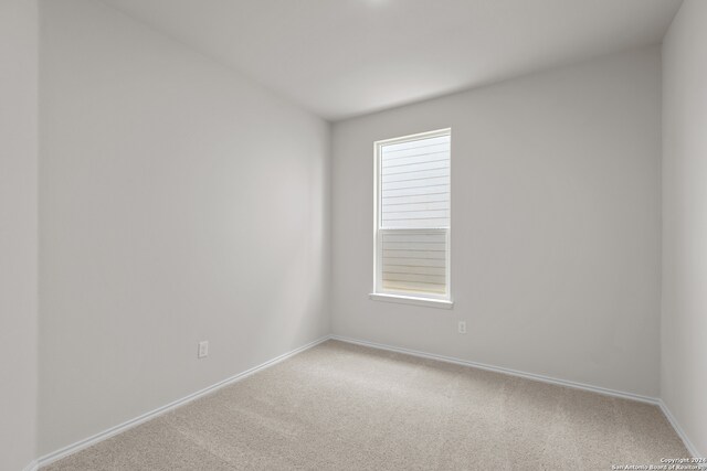 empty room featuring light colored carpet