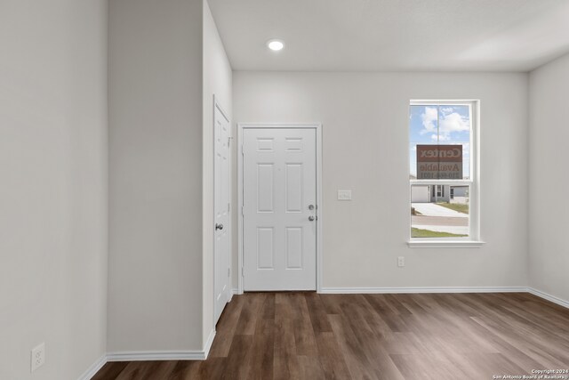 empty room with dark wood-type flooring