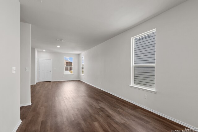 spare room featuring dark hardwood / wood-style flooring