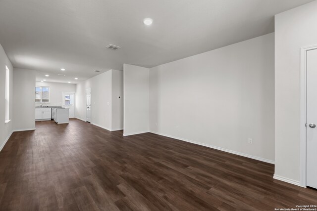 unfurnished living room with dark hardwood / wood-style floors