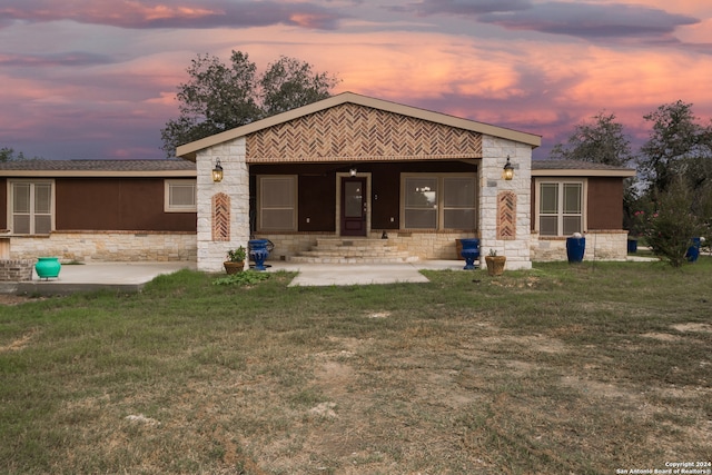 back house at dusk with a yard