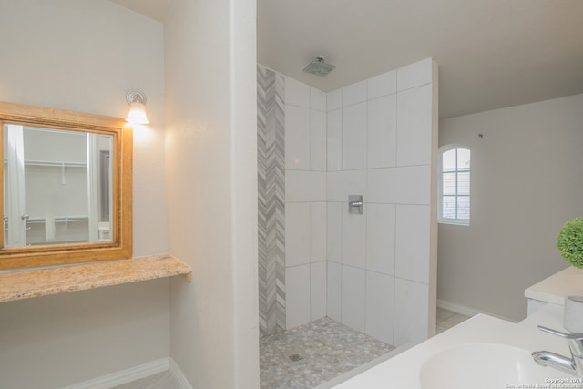 bathroom featuring vanity and a tile shower