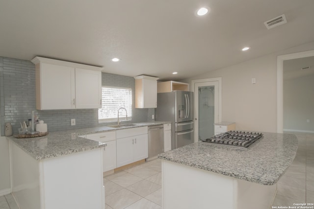 kitchen with white cabinetry, a center island, sink, appliances with stainless steel finishes, and light tile patterned flooring