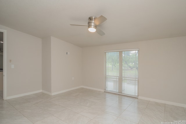 unfurnished room with ceiling fan and light tile patterned floors