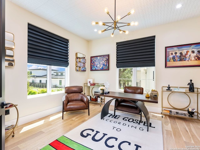 office space with light hardwood / wood-style floors and a notable chandelier