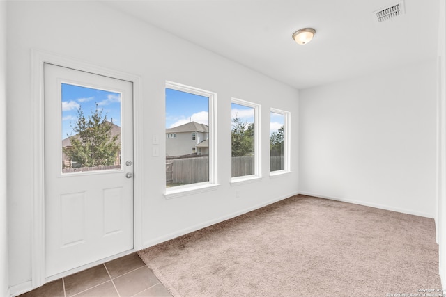 entryway with tile patterned flooring, visible vents, and baseboards