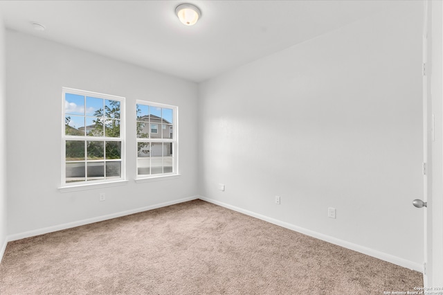 carpeted spare room with baseboards