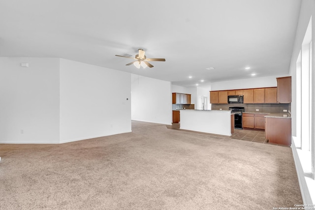 unfurnished living room featuring recessed lighting, a ceiling fan, and light colored carpet