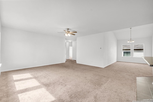 unfurnished living room with carpet flooring, baseboards, and ceiling fan with notable chandelier