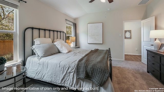 carpeted bedroom with vaulted ceiling and ceiling fan