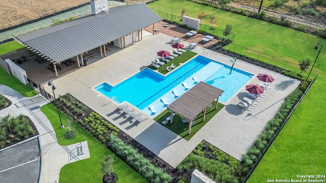 view of swimming pool with a lawn and a patio