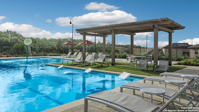 view of swimming pool featuring a yard, a patio, and a pergola