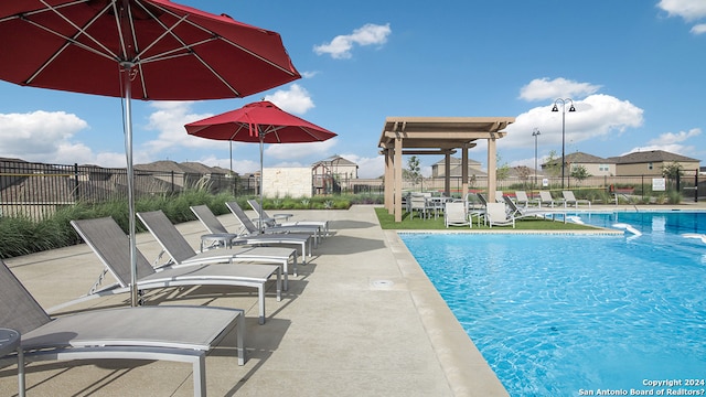 view of swimming pool with a patio