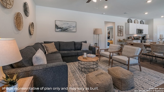 living room with ceiling fan and light hardwood / wood-style flooring