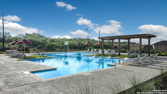 view of swimming pool featuring a patio and a pergola